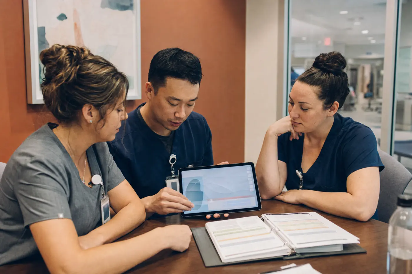 Healthcare professionals reviewing training material