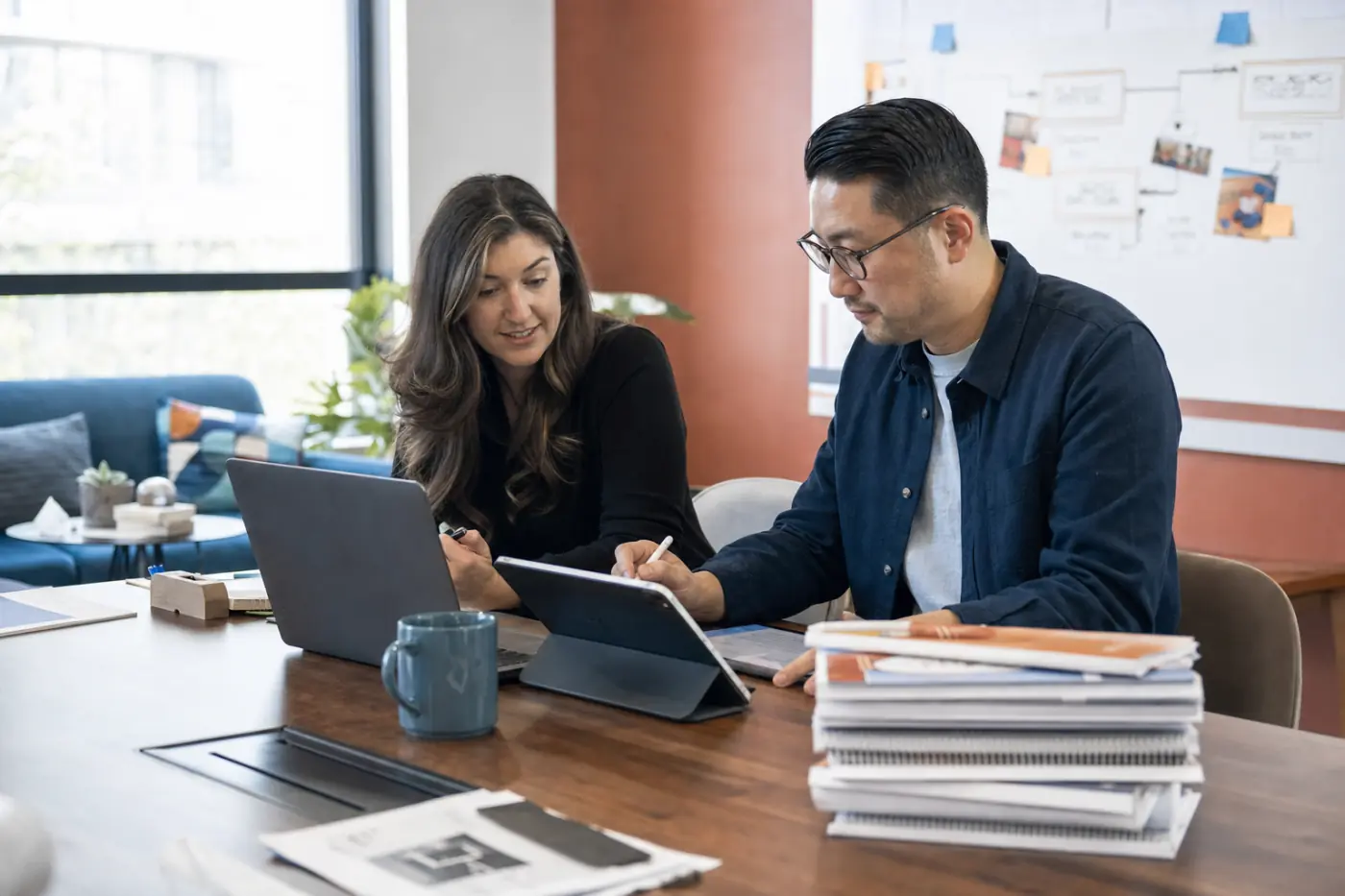 Two colleagues preparing digital training materials together